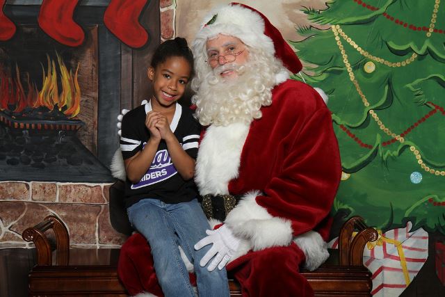 Santa Claus with child at North Texas holiday visit near Plano